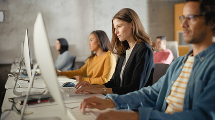 Beautiful Smart Female Student, Studying in Modern University with Diverse Multiethnic Classmates. College Scholars Work in College Room, Learning IT, Programming or Computer Science.