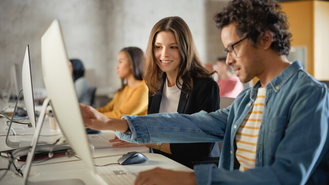 Beautiful Smart Female Student, Studying in University with Diverse Multiethnic Classmates. She Asks Scholar a Question in College Room. Applying Her Knowledge to Acquire Academic Skills in Class.