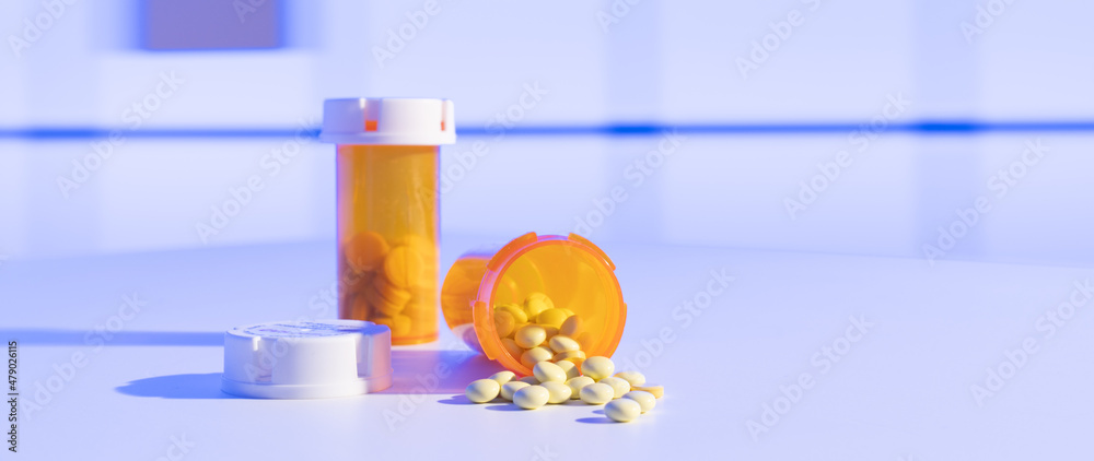 Poster Medical pills and tablets spilling out  drug bottle. View with copy space.