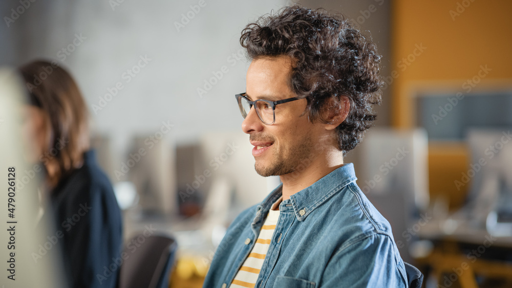 Poster portrait of a handsome smart male student, studying in university, fondly smiling. he wears glasses 