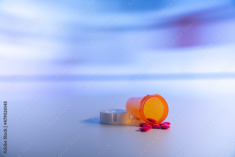 Wall mural Medical pills and tablets spilling out  drug bottle. View with copy space.