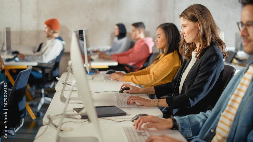 Aufkleber diverse multiethnic group of female and male students sitting in college room, learning computer sci