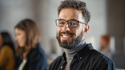 Portrait of a Handsome Smart Male Student, Studying in University, Fondly Smiling on Camera. He...