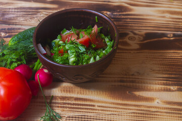 Delicious vegetable salad of fresh vegetables on a wooden table