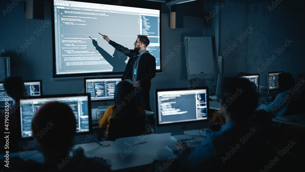 Leinwandbilder Teacher Giving Computer Science Lecture to Diverse Multiethnic Group of Female and Male Students in Dark College Room. Projecting Slideshow with Programming Code. Explaining Information Technology.
