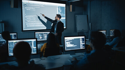 Teacher Giving Computer Science Lecture to Diverse Multiethnic Group of Female and Male Students in Dark College Room. Projecting Slideshow with Programming Code. Explaining Information Technology. - obrazy, fototapety, plakaty