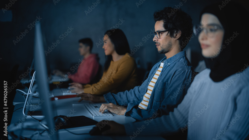 Fototapete Diverse Multiethnic Group of Female and Male Students Sitting in College Room, Learning Computer Science. Young Scholars Study Information Technology on Computers in University, Writing Code in Class.