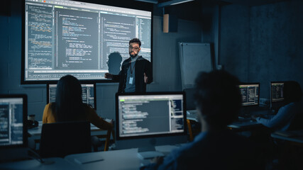 Teacher Giving Computer Science Lecture to Diverse Multiethnic Group of Female and Male Students in...