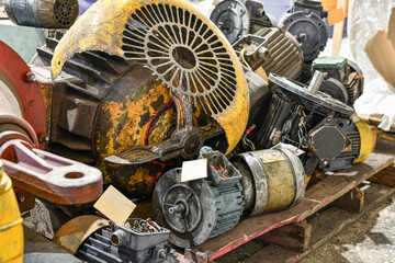 Old burned out and broken electric motors in a warehouse at a factory.