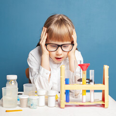 Small child girl making experiment. Research, education and science in modern school