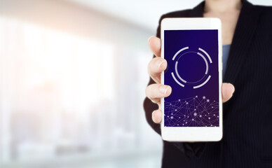 Business network communication and innovation technology concept. Hand hold white smartphone with digital hologram circular diagram sign. Abstract background with mock up circular diagram virtual.