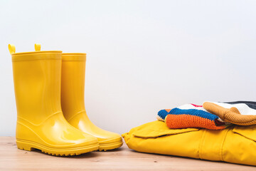 Clothes and boots. Seasonal shopping and sales. Yellow rain boots and outumn outfit.