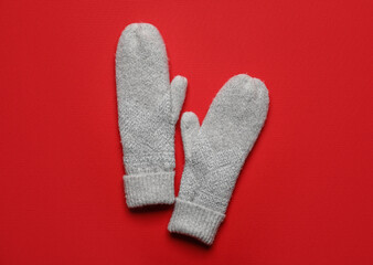 Warm mittens on red background