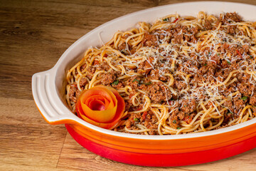 Spaghetti with Bolognese sauce made from fresh tomatoes, minced meat, onion, garlic and grated cheese  (Selective focus ).