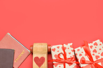 Wooden car with heart, passports and gift boxes on red background. Valentine's Day celebration