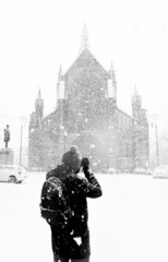 A lone photographer captures a snow scene of Glasgow Cathedral during harsh winter conditions. Scotland.