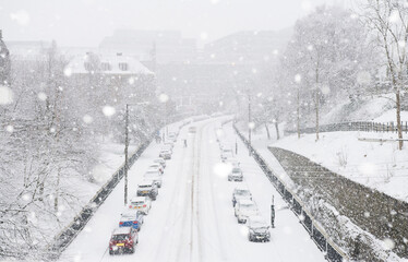 Snow-covered road in Glasgow. Wishart Street, Glasgow. Parked cars line the street during snow conditions in winter.