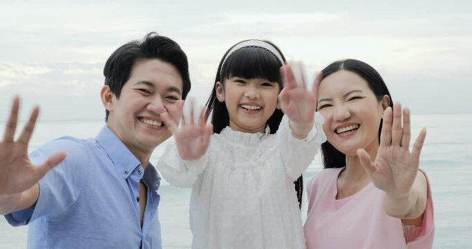 Portrait of asian family people looking to camera with smile. They travel at the beach together. Summer, Lifestyle and Family concept.