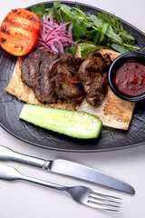 traditional Caucasian dish kebabs with vegetables and sauce