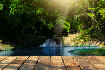 wooden table with beautiful waterfall background and nature