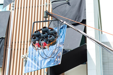 Process of filming. Spotlight illuminates. Movie set with many lamps outdoor. Movie lights outdoor