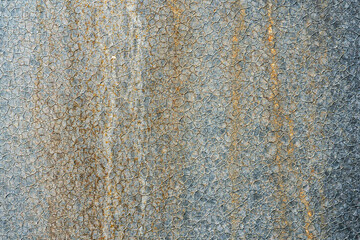 An empty concrete surface with cracks and traces of old paint. The background is a painted old wall. A place to insert text or design.