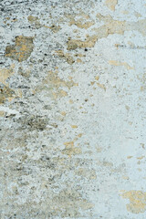 Empty background is an old painted concrete wall. The texture of the wall with cracks, lichen and mold. A destroyed building after a cataclysm or tornado.