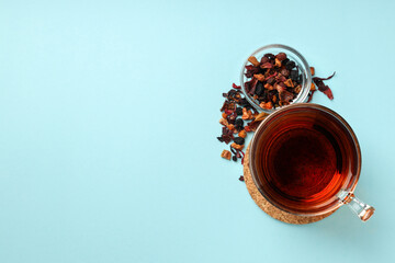 Concept of hot drink with tea on blue background