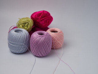 Wool yarn in different colors with wooden double point needles. The needles are being used for knitting socks, mittens or other projects joined in the round.