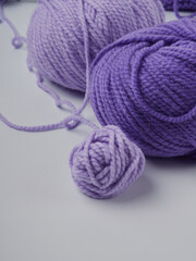 Wool yarn in different colors with wooden double point needles. The needles are being used for knitting socks, mittens or other projects joined in the round.