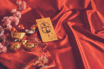 Decoration focus on gold bullion design Chinese New Year 2022 Red cloth background with greeting...