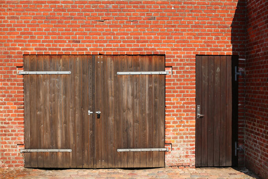 Wooden garage door in typical danish red brick stone building