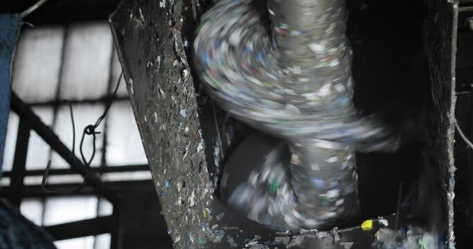 View of a rotating rotor that shreds plastic into small pieces. Recycling. Waste shredder. Environmental protection concept.