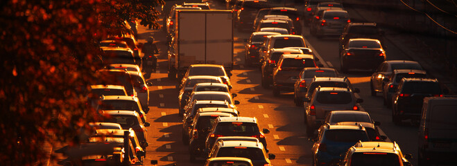 Traffic jam at sunset. Paralyzed traffic on city streets. - obrazy, fototapety, plakaty