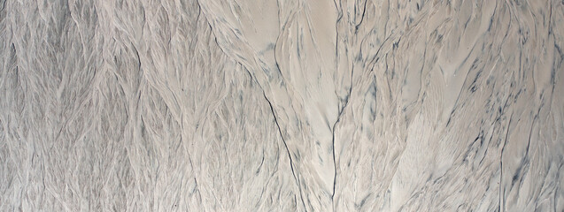 Traces of erosion on sand texture. Natural abstract background.