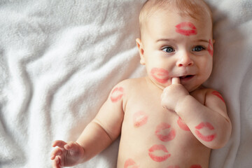 Cheerful baby with traces of kisses on the body. V