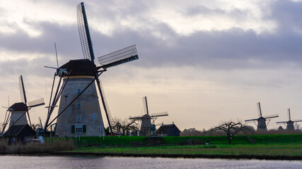 Naklejka premium Windmills on a very cloudy day at Kinderdijk in The Netherlands.