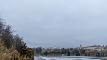 Fototapeta na wymiar Dark waters of the river with thin plates of ice. The first ice on the river in center of Minsk.