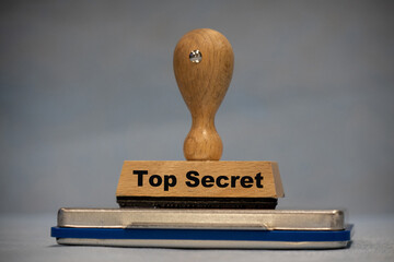 on a wooden stamp is the word top secret