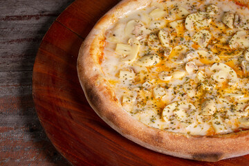Tasty Mushroom Pizza on wooden background, in Brazil it's called pizza de cogumelos