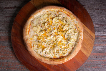 Tasty Mushroom Pizza on wooden background, in Brazil it's called pizza de cogumelos