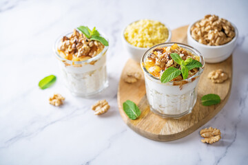 Greek yogurt millet caramelized apple walnuts parfait in a glass