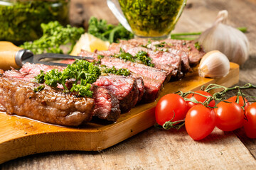 Beef steak cooked and sliced close-up. Wooden table. Selective focus.