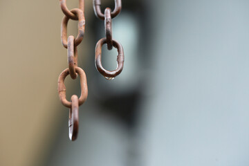antique rusty iron chain hanging, isolated with blurred background.