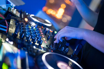 Dj mixing at party festival with light and smoke in background - Summer nightlife view of disco...