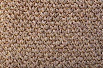 Texture of beige knitted woolen fabric for wallpaper and an abstract background