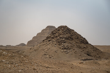 View to Userkaf pyramid with Step pyramid of Djoser at background.  Archeological remain in the Saqqara necropolis, Egypt