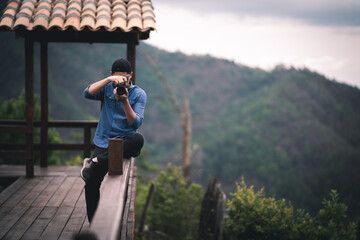 person on a mountain taking photos