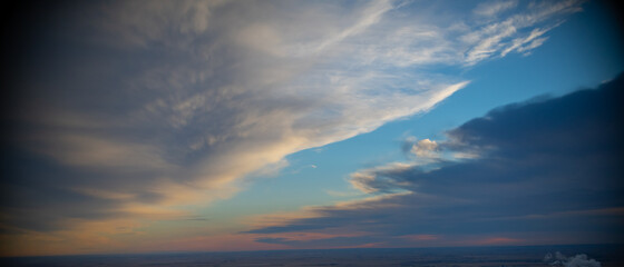 heavenly clouds in blue sky white and grey colors in clouds parted to reveal blue sky in heavens...