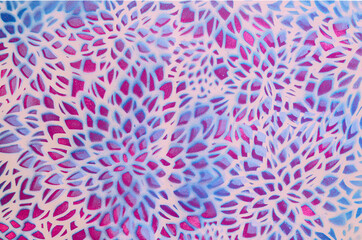 A background or wallpaper made of flower petals shapes in blue and magenta on pastel pink background. Seamless pattern for advertisment or card or web banner. Flat lay